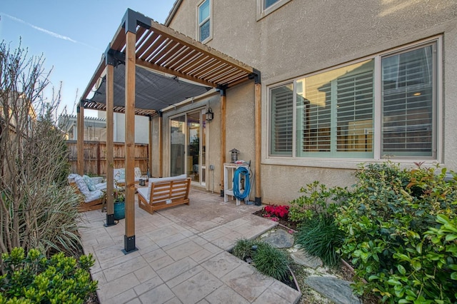 view of patio featuring an outdoor hangout area, a pergola, and fence