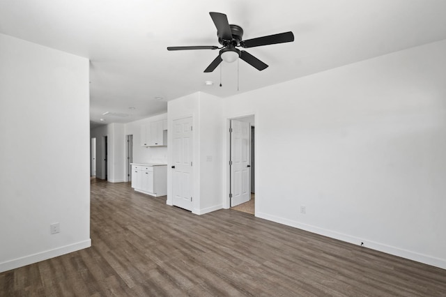 unfurnished living room featuring a ceiling fan, baseboards, and dark wood-style flooring