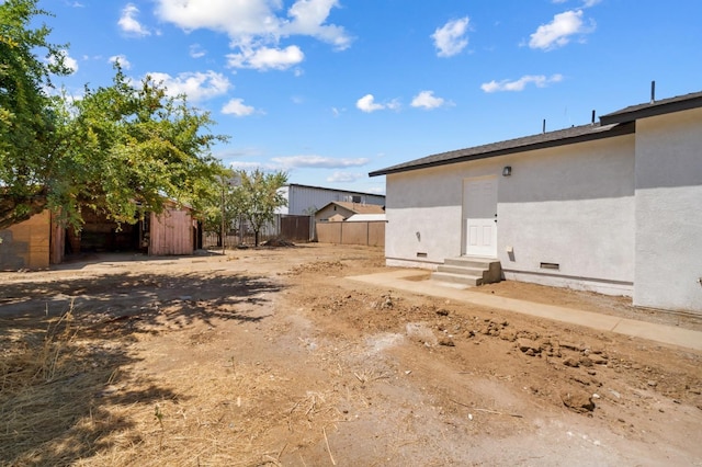 view of yard with entry steps and fence