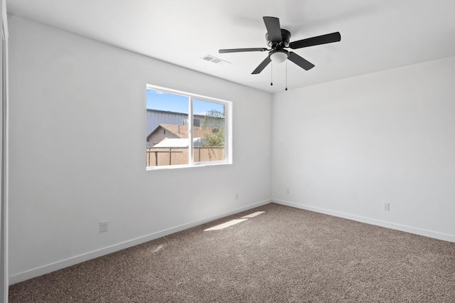 empty room with ceiling fan, carpet, visible vents, and baseboards