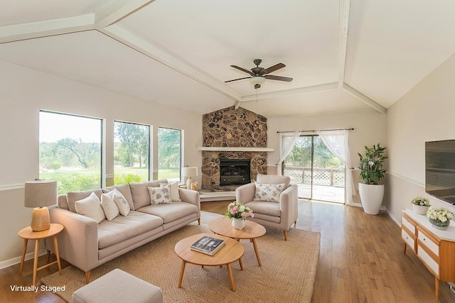 41371 Butte Way, Madera, CA 93636 - living room featuring wood finished floors, ceiling fan, and a stone fireplace