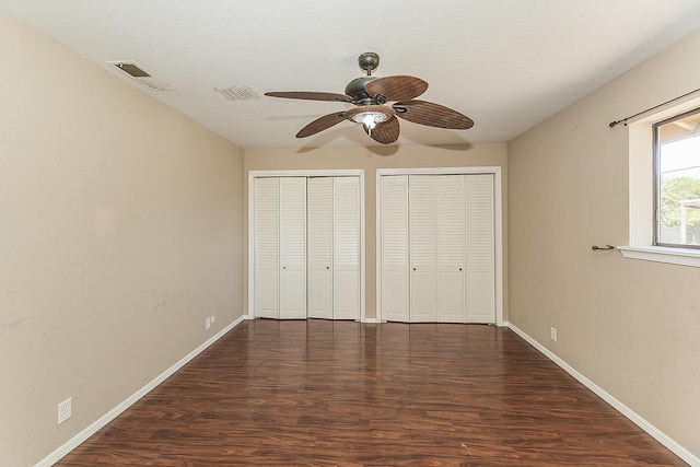 41371 Butte Way, Madera, CA 93636 - unfurnished bedroom featuring multiple closets, wood finished floors, and a ceiling fan