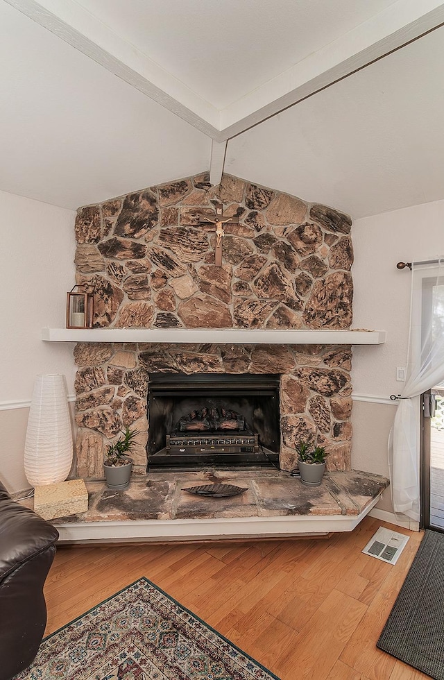 41371 Butte Way, Madera, CA 93636 - detailed view of beamed ceiling, a stone fireplace, and wood finished floors