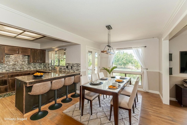 41371 Butte Way, Madera, CA 93636 - dining room with light wood-style floors and ornamental molding