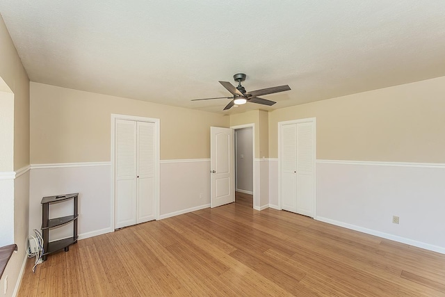 41371 Butte Way, Madera, CA 93636 - unfurnished bedroom with light wood finished floors and a ceiling fan