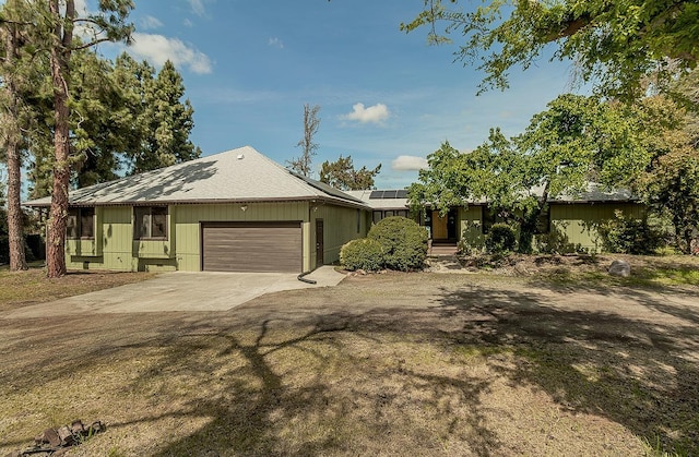 41371 Butte Way, Madera, CA 93636 - view of front of property featuring concrete driveway, an attached garage, and solar panels