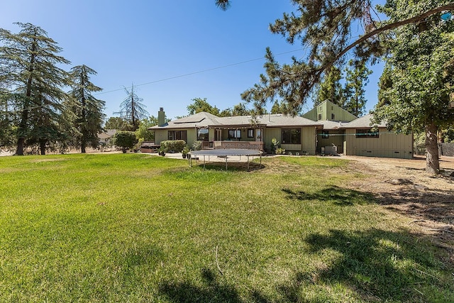 41371 Butte Way, Madera, CA 93636 - rear view of house with a trampoline, a yard, and crawl space