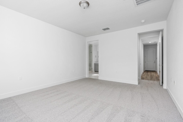 unfurnished bedroom with visible vents, carpet flooring, and baseboards