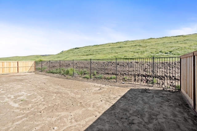 view of yard with a rural view and fence