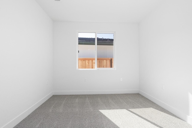 spare room with carpet flooring and baseboards