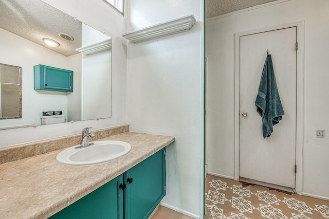 bathroom with a textured ceiling and vanity