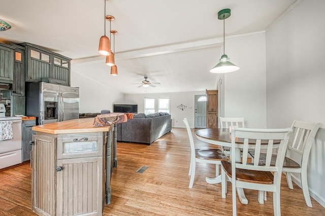 kitchen featuring a ceiling fan, white range with electric cooktop, butcher block countertops, stainless steel fridge, and light wood-type flooring