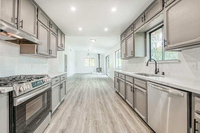 42741 Revis Way, Coarsegold, CA 93614 - kitchen featuring appliances with stainless steel finishes, under cabinet range hood, gray cabinetry, light wood-style flooring, and recessed lighting