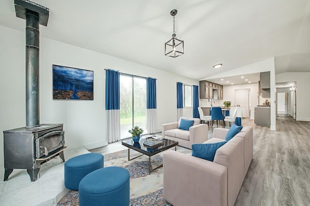 42741 Revis Way, Coarsegold, CA 93614 - living room featuring lofted ceiling, a wood stove, light wood-style flooring, and recessed lighting