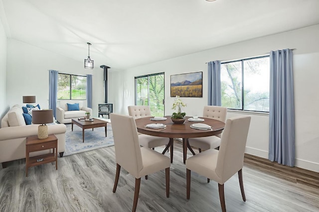 42741 Revis Way, Coarsegold, CA 93614 - dining area with a wood stove, wood finished floors, healthy amount of natural light, and lofted ceiling