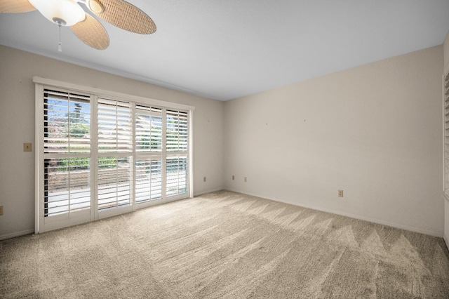 unfurnished room with carpet, ceiling fan, and baseboards