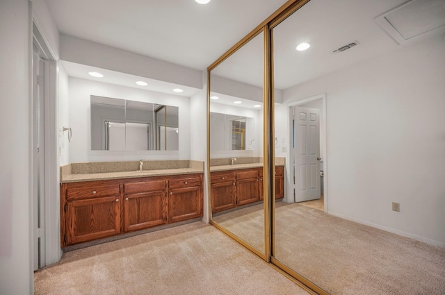 bathroom featuring carpet, vanity, and recessed lighting