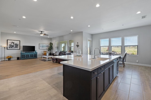 958 Beaver Pond, Madera, CA 93636 - kitchen with recessed lighting, healthy amount of natural light, light countertops, open floor plan, and a kitchen island with sink