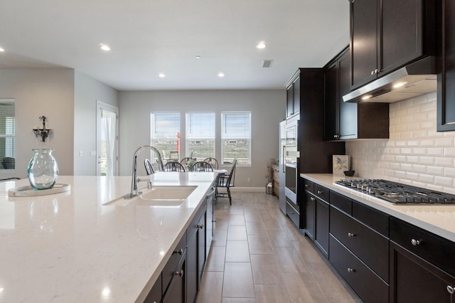 958 Beaver Pond, Madera, CA 93636 - kitchen featuring stainless steel appliances, under cabinet range hood, tasteful backsplash, recessed lighting, and light stone counters