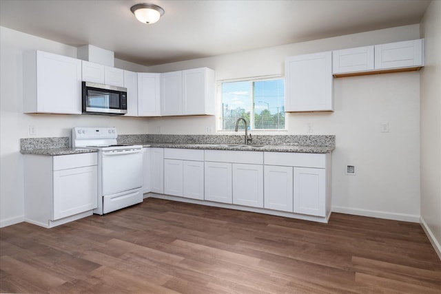 430 S Thorne Ave, Fresno, CA 93706 - kitchen with stainless steel microwave, electric stove, white cabinets, and dark wood finished floors