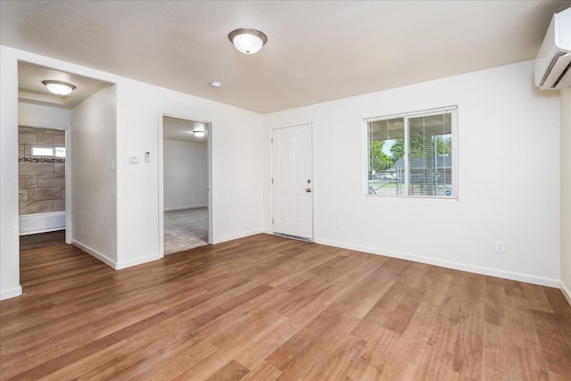 430 S Thorne Ave, Fresno, CA 93706 - spare room with a wall mounted air conditioner, light wood finished floors, and healthy amount of natural light