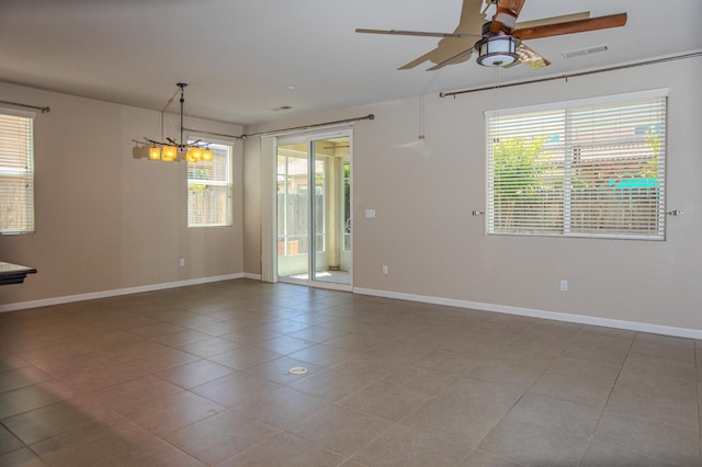3418 El Molino, Clovis, CA 93619 - spare room featuring a ceiling fan, plenty of natural light, light tile patterned flooring, and a chandelier