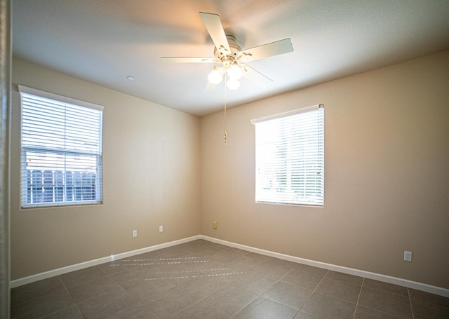 3418 El Molino, Clovis, CA 93619 - unfurnished room featuring a ceiling fan and dark tile patterned flooring