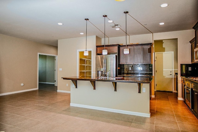 3418 El Molino, Clovis, CA 93619 - kitchen featuring appliances with stainless steel finishes, backsplash, a breakfast bar area, light tile patterned floors, and recessed lighting