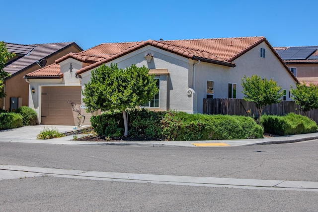 3418 El Molino, Clovis, CA 93619 - mediterranean / spanish-style home featuring a garage, stucco siding, a tile roof, and concrete driveway