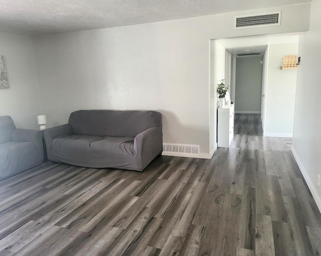 4336 E Austin Way, Fresno, CA 93726 - living room with dark wood-style flooring, baseboards, and a textured ceiling