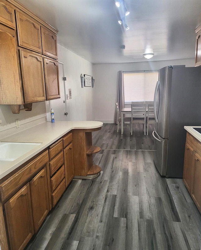 4336 E Austin Way, Fresno, CA 93726 - kitchen with freestanding refrigerator, brown cabinets, and dark wood-style flooring