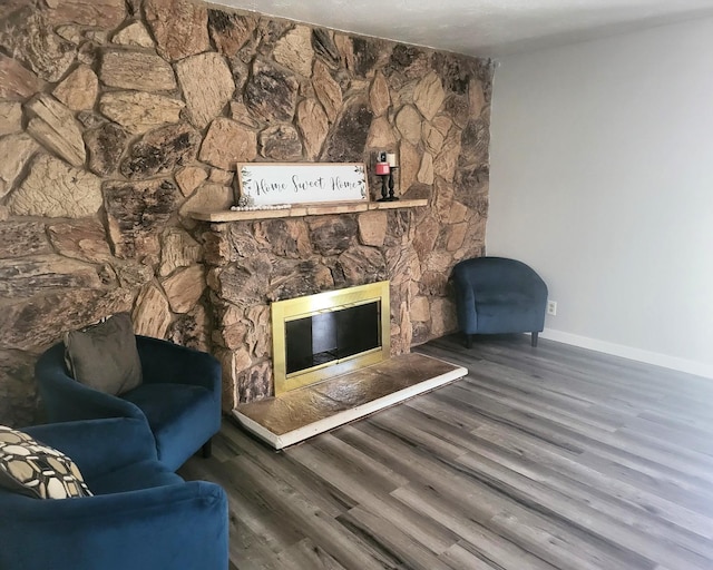 4336 E Austin Way, Fresno, CA 93726 - living area featuring a stone fireplace, baseboards, and wood finished floors
