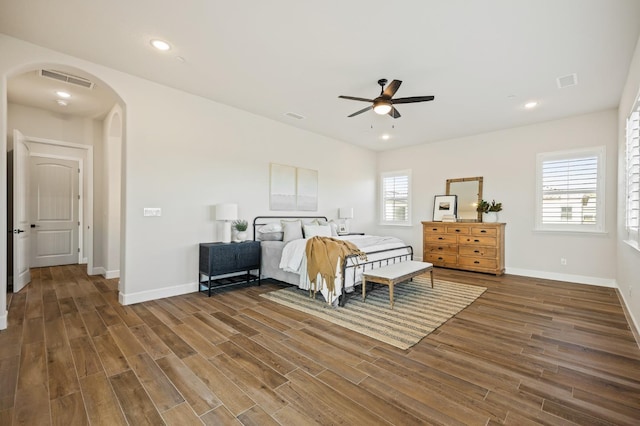 bedroom featuring visible vents, recessed lighting, wood finished floors, and arched walkways