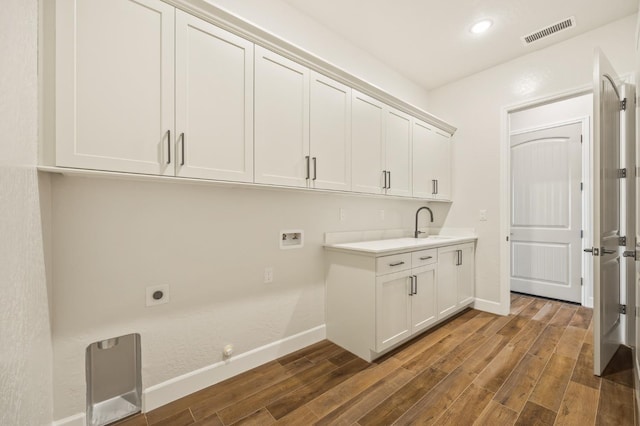 laundry area with visible vents, washer hookup, dark wood-style floors, cabinet space, and hookup for an electric dryer