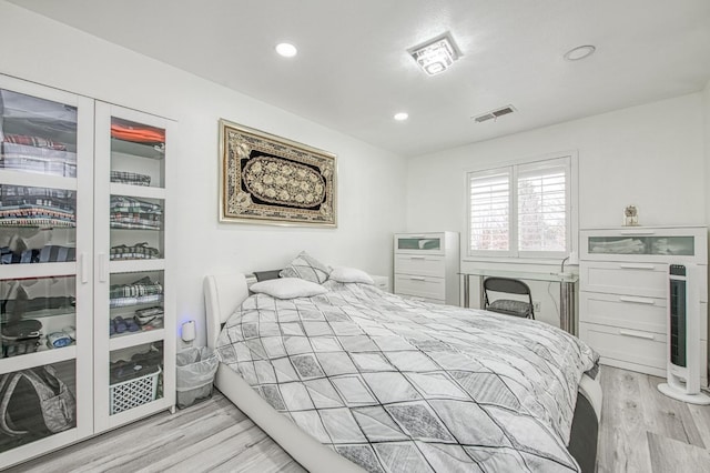 bedroom featuring visible vents, recessed lighting, and wood finished floors