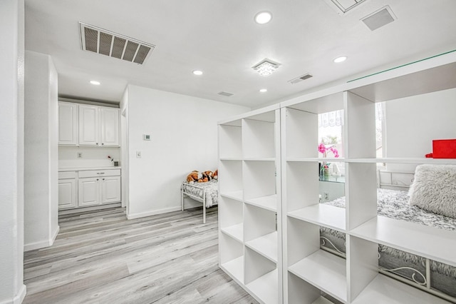 interior space with baseboards, visible vents, recessed lighting, and wood finished floors