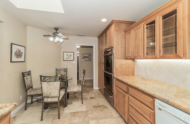 kitchen featuring tasteful backsplash, dishwasher, double oven, baseboards, and visible vents