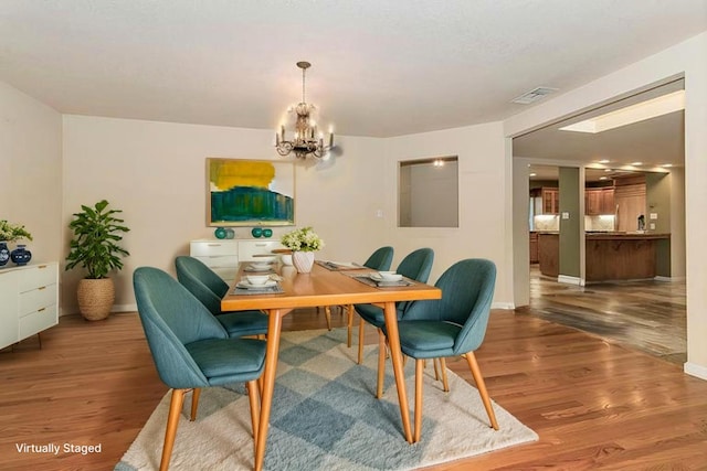 411 W Vartikian Ave W, Fresno, CA 93704 - dining area with a chandelier and wood finished floors