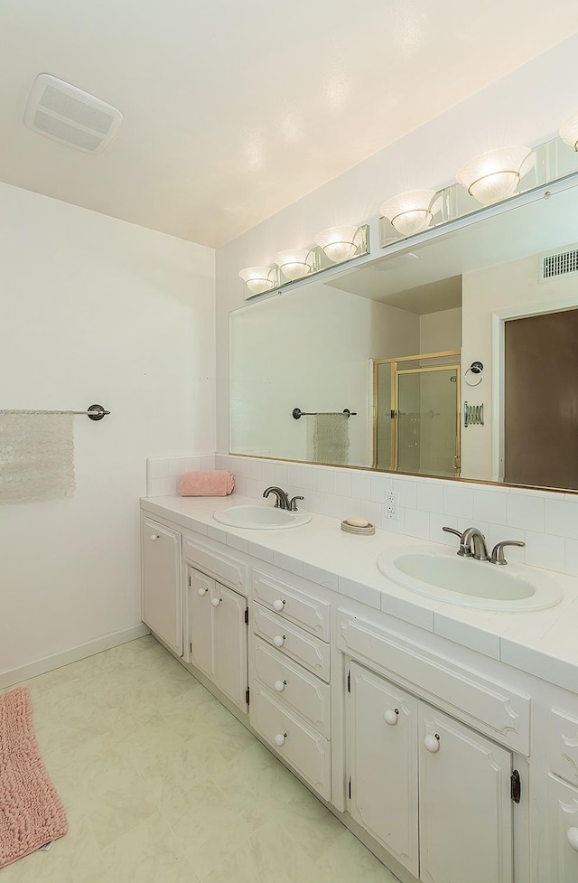 full bathroom with a sink, visible vents, and a stall shower