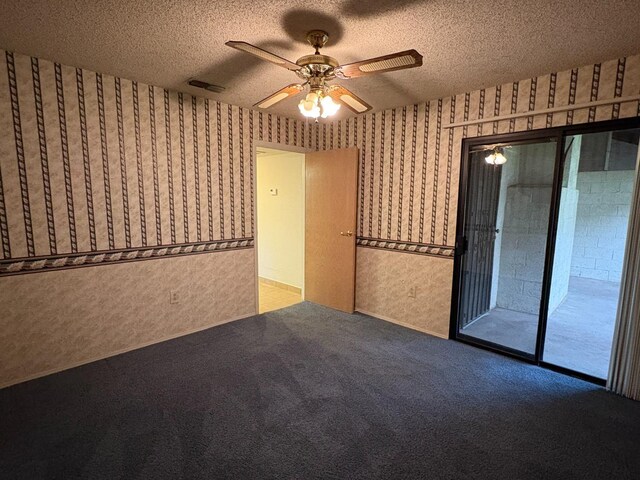 2512 Driftwood Dr, Madera, CA 93637 - carpeted empty room with visible vents, a textured ceiling, wallpapered walls, and a ceiling fan