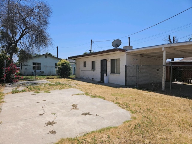 2690 S Cedar, Fresno, CA 93725 - rear view of house featuring fence and concrete block siding