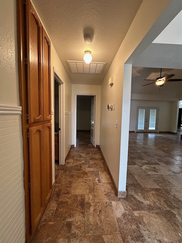 18149 Varden Dr, Madera, CA 93638 - hall with visible vents, stone finish floor, baseboards, and a textured ceiling