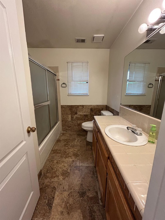 18149 Varden Dr, Madera, CA 93638 - full bath featuring vanity, tile walls, toilet, visible vents, and a shower with shower door