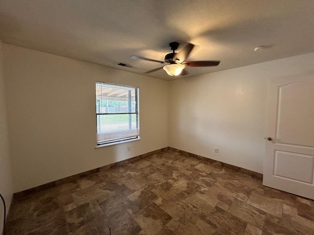 18149 Varden Dr, Madera, CA 93638 - unfurnished room with stone finish floor, baseboards, a textured ceiling, ceiling fan, and visible vents