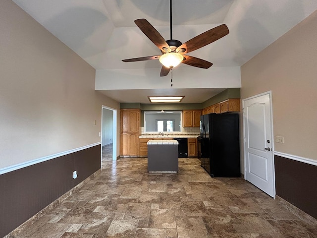 18149 Varden Dr, Madera, CA 93638 - kitchen with light countertops, a sink, ceiling fan, black appliances, and brown cabinetry