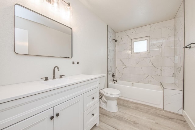full bathroom featuring vanity,  shower combination, wood finished floors, and toilet