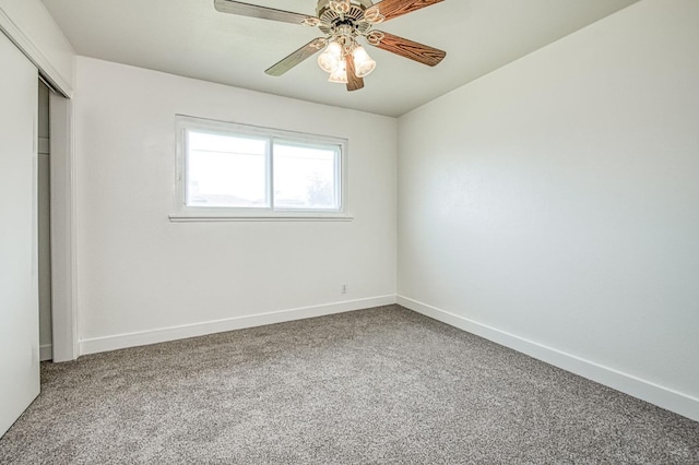 unfurnished bedroom with carpet floors, baseboards, ceiling fan, and a closet