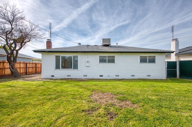 rear view of property featuring a fenced backyard, a chimney, central AC unit, crawl space, and a lawn