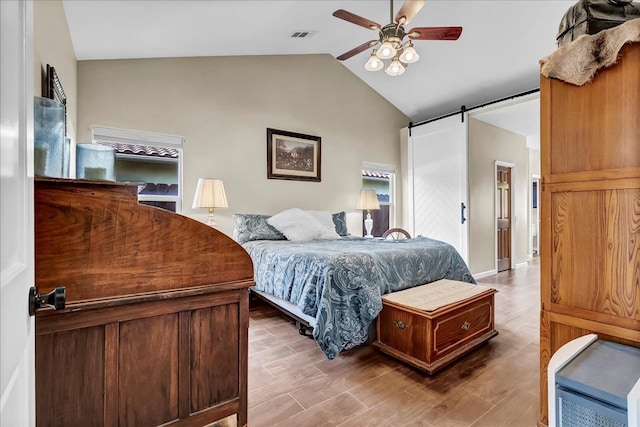 355 Old Line Ave, Exeter, CA 93221 - bedroom with a barn door, vaulted ceiling, wood finished floors, and ceiling fan