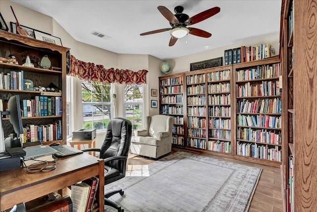 355 Old Line Ave, Exeter, CA 93221 - office area with wall of books, wood finished floors, visible vents, and ceiling fan